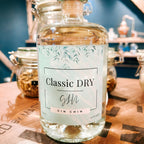Bottle of Classic Dry Gin Chin small batch gin on a wooden surface with a blurred background