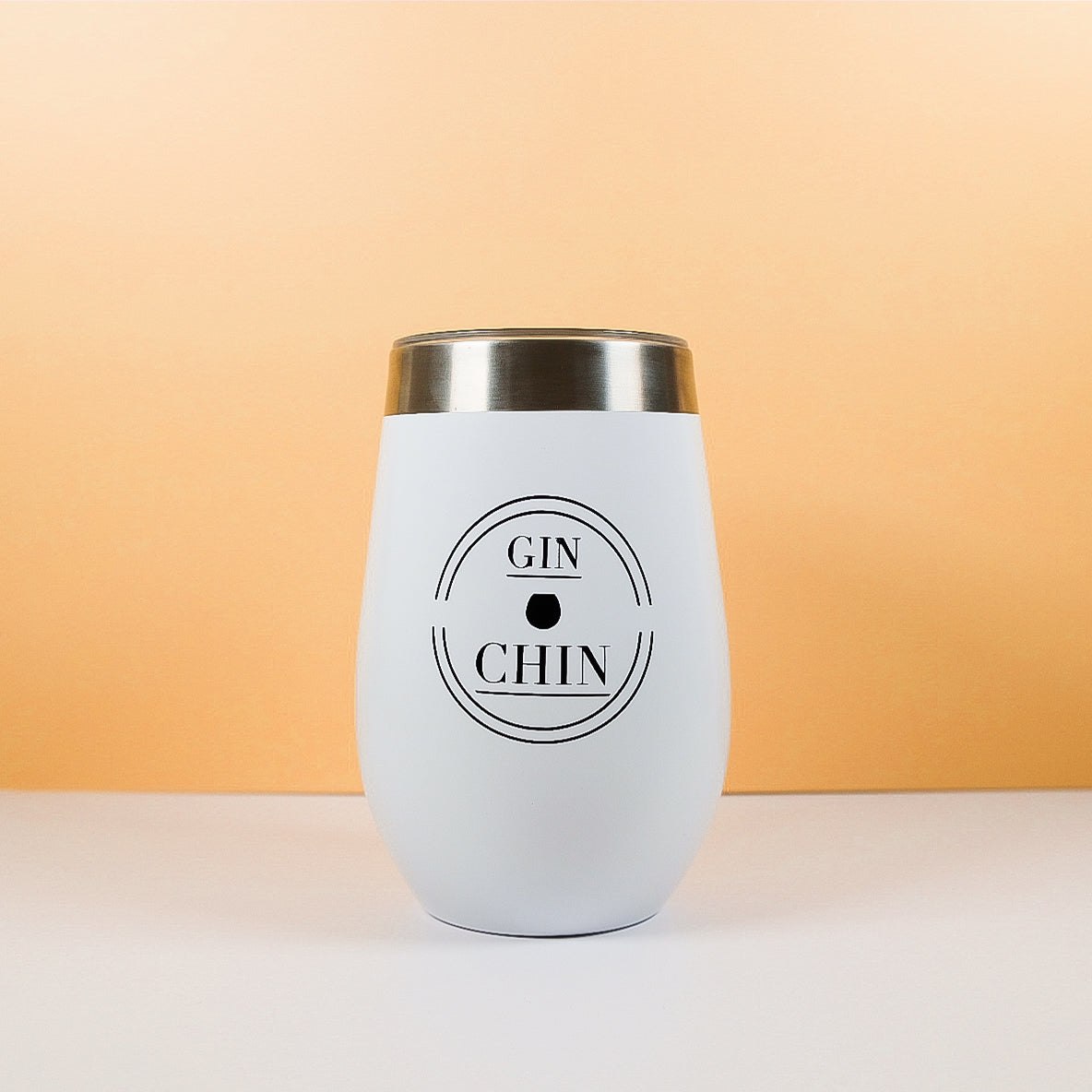 White insulated travel tumbler with 'GIN CHIN' text on a peach background