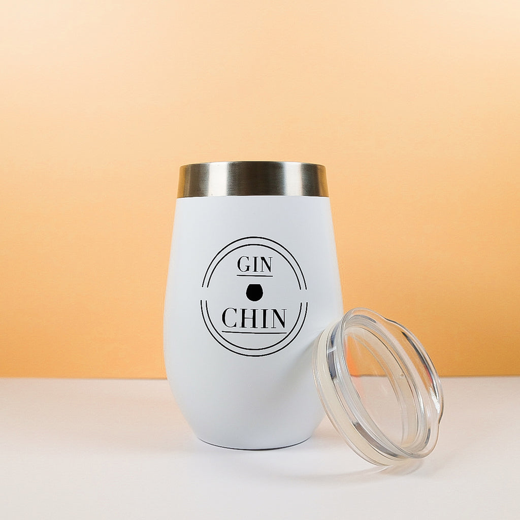 White gin tumbler with 'GIN & CHIN' text on a peach background