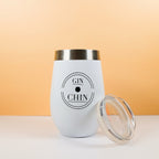 White gin tumbler with 'GIN & CHIN' text on a peach background