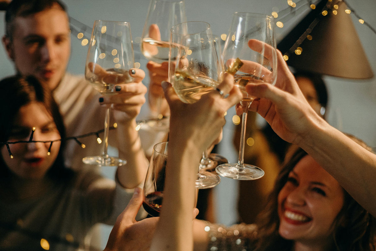 People toasting with glasses of champagne at a party.