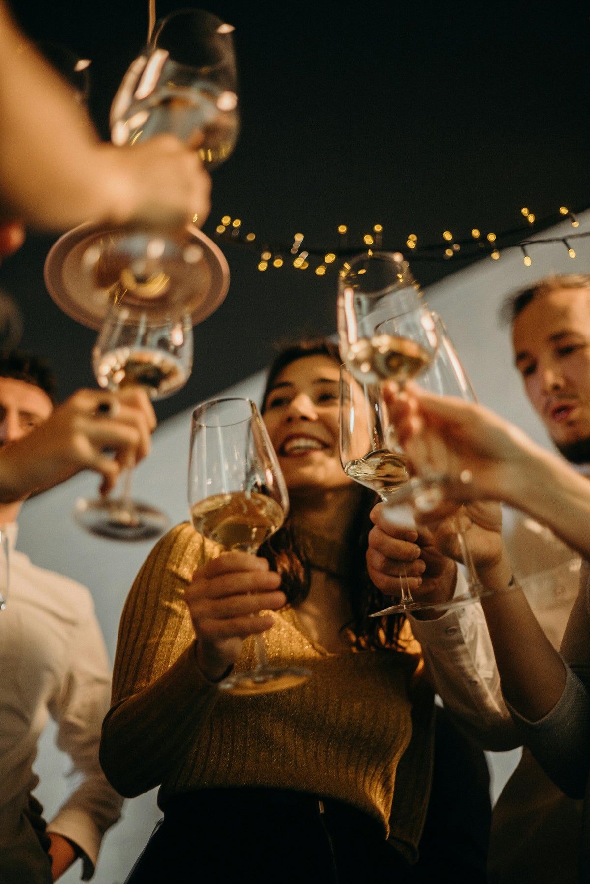 People toasting with gin glasses at a social gathering